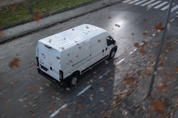 A Toyota Proace drives a long country road