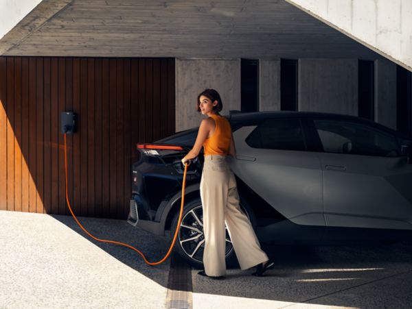 'An owner charges a Toyota C-HR Plug-in Hybrid at home 